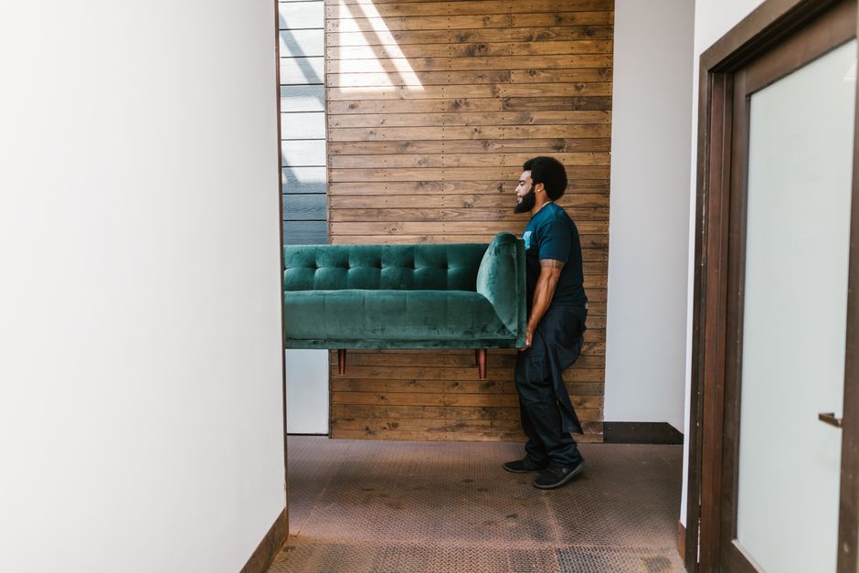 Local movers carrying heavy furniture